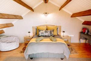 a bedroom with a large bed in a attic at Breathe Accommodation in Oudtshoorn