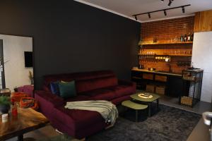 a living room with a red couch and a table at Oldtown Apartment in Prishtina in Pristina
