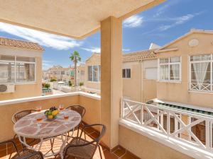 a patio with a table and chairs on a balcony at Casa Alegria apartment with pool & prv jacuzzi in Torrevieja
