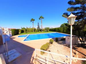 a swimming pool in a yard with a street light at Casa Alegria apartment with pool & prv jacuzzi in Torrevieja