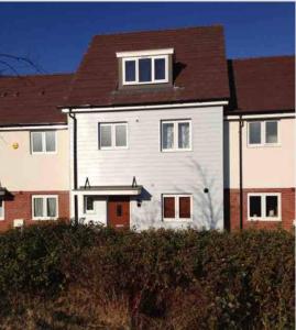 a large white house with a brown roof at DARTFORD CROSSING The BRIDGE PLACE - CONTRACTORS FAVOURITE in Kent