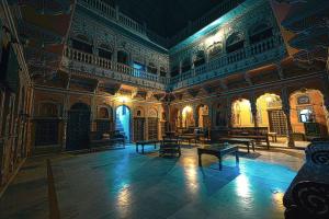 a large room with benches in a building at Hotel Radhika Haveli, Mandawa in Mandāwa