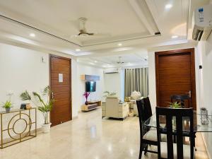 a large living room with a table and chairs at Bedchambers Serviced Apartments, Ardee City in Gurgaon