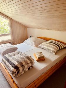 a bed with two pillows on it in a room at Komfort-Ferienhaus Sonnental in Extertal