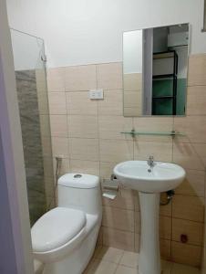 a bathroom with a toilet and a sink at St. Marvin Studio Makati M208 in Manila