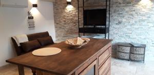 a kitchen with a table and a couch and a television at logement individuel in Le Cannet