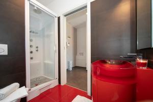 a bathroom with a red stool and a shower at Via al Chioso in Lugano