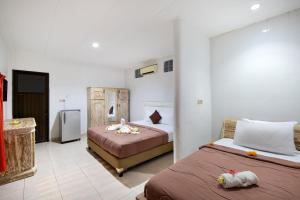 Postel nebo postele na pokoji v ubytování Hotel Lumbung Sari Legian