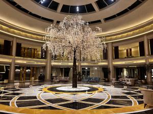 a large lobby with a tree in the middle of it at KaiSol Romance Resort Sahl Hasheesh - Adults Only in Hurghada