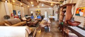 a living room with a couch and a table at Ugly Darling Farmstyle B&B in Krugersdorp