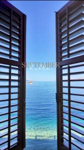 une fenêtre ouverte donnant sur l'océan dans l'établissement Beach rooms Riviera - Žuta Kuća, à Makarska