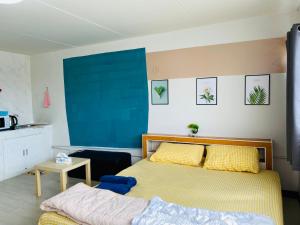 a bedroom with a bed and a blue wall at Condo popular T8 fl.6 in Thung Si Kan
