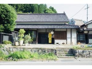 a house with a yellow door on the front of it at Hyogo private house yogoto - Vacation STAY 00235v in Kamikawa