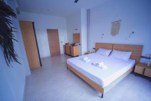 a bedroom with a bed with two white towels on it at Mantra Sea View Villa in Chaloklum