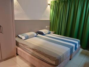 Tempat tidur dalam kamar di Batu Ferringhi Sri Sayang Resort