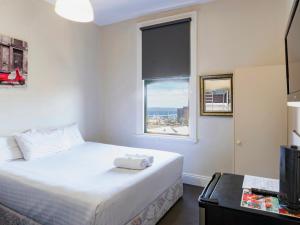 a hotel room with a bed and a window at Six Degrees Boutique Hotel in Albany +26 photos