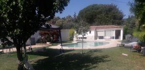 a house with a swimming pool in a yard at logement individuel in Le Cannet