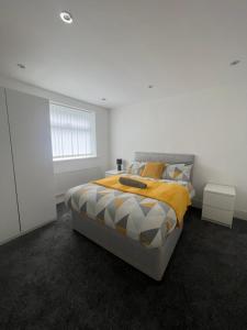 a white bedroom with a bed and a window at Modern 4 Bed - 10 mins to centre in Liverpool