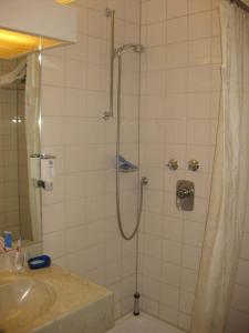 a bathroom with a shower with a sink and a toilet at Abakus-Hotel in Sindelfingen