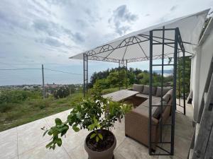 a patio with a couch and a canopy at Вила Вилекула in Varna City