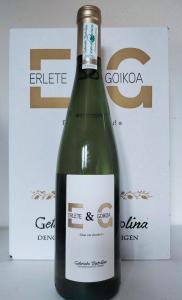 a bottle of green wine in front of a box at Agroturismo Erlete Goikoa -ESTAMOS EN EL CAMINO DE SANTIAGO -WE ARE ON THE CAMINO DE SANTIAGO in Deba