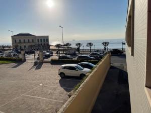 un coche aparcado en un estacionamiento junto al océano en Monolocale fronte mare, en Livorno