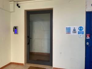 a door in a building with a sign next to it at Monolocale fronte mare in Livorno