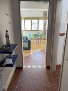a hallway with a living room and a dining room at Monolocale fronte mare in Livorno