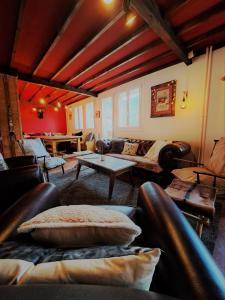 a living room with leather furniture and a table at Les Mouflons in Le Mont-Dore