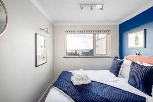 a bedroom with a bed with two towels on it at Sunset Beach House Porthleven in Porthleven +13 photos