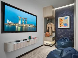 a living room with a flat screen tv on a wall at Marina Bay Sands in Singapore