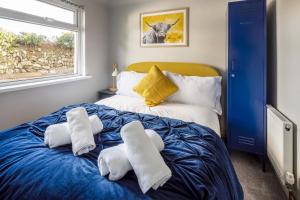 a bedroom with a bed with two towels on it at Sunset Beach House Porthleven in Porthleven