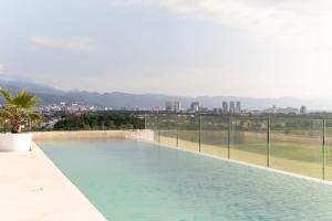 a swimming pool with a view of the city at Sunset Paradise Residence in Puerto Vallarta