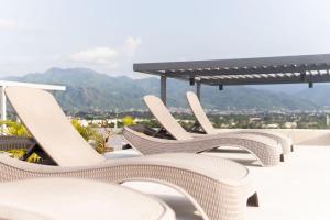 a row of white chairs sitting on top of a roof at Sunset Paradise Residence in Puerto Vallarta
