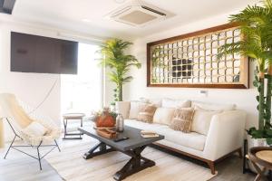 a living room with a white couch and a table at Sunset Paradise Residence in Puerto Vallarta