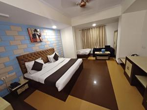 a hotel room with a bed and a desk at Hotel V inn Sindhi Camp in Jaipur