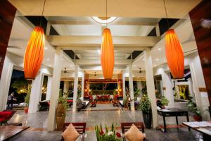 a lobby of a resort with orange chandeliers at Luangprabang View Hotel in Luang Prabang