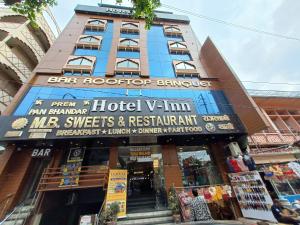 a building with a sign on the front of it at Hotel V inn Sindhi Camp in Jaipur