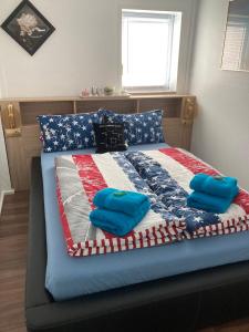 a bed with an american flag quilt on it at Fewo im Alten Land in Hamburg