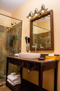 a bathroom with a sink and a mirror at Acacia Tree Lodge in Nairobi