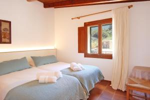 A bed or beds in a room at Cala Estellencs Beach House by Slow Villas