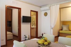 a living room with a table with a bowl of fruit at Casa Vacanze Bouganvillea in Cetara