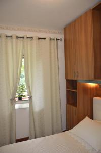 a bedroom with a bed and a window at Casa Vacanze Bouganvillea in Cetara