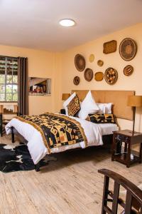 a bedroom with a bed and some plates on the wall at Acacia Tree Lodge in Nairobi