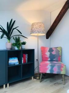 a living room with a lamp and a chair at Qwadrat Apartament 15 in Bielsko-Biala city center in Bielsko-Biala