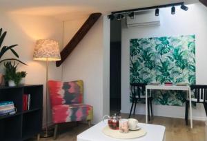 a living room with a table and a chair at Qwadrat Apartament 15 in Bielsko-Biala city center in Bielsko-Biala