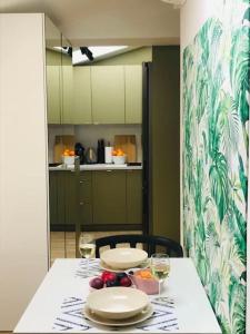 a table with two plates and wine glasses on it at Qwadrat Apartament 15 in Bielsko-Biala city center in Bielsko-Biala +18 photos