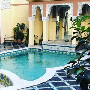 a swimming pool in the courtyard of a building at Riad Zitouna in Fez