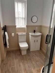 a bathroom with a toilet and a sink at 73 George Street. Appartment 1 in Oban
