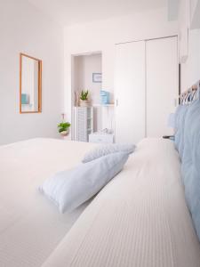 a white bedroom with white walls and a large white bed at A 50 scalini dal mare - Camera Doppia Privata in Maratea